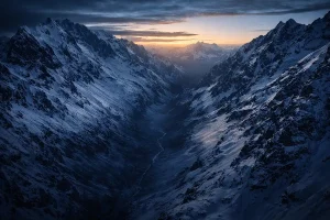 Snow-covered Andes mountains at dusk representing Nando Parrado survival story - motivational speaker resilience leadership | Aurum Speakers Bureau
