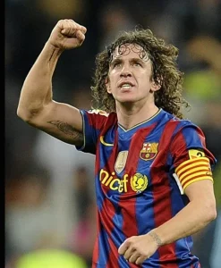 Carles Puyol celebrating in a Barcelona shirt wearing the captain’s armband, symbolizing leadership and team culture