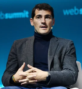 Iker Casillas speaking on stage at a business event, sharing leadership insights