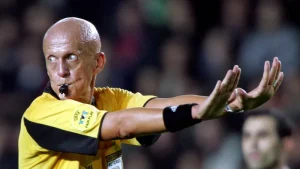 Pierluigi Collina refereeing a football match, signaling decisively during play