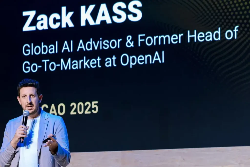 Zack Kass speaking on stage about AI and the future of human potential