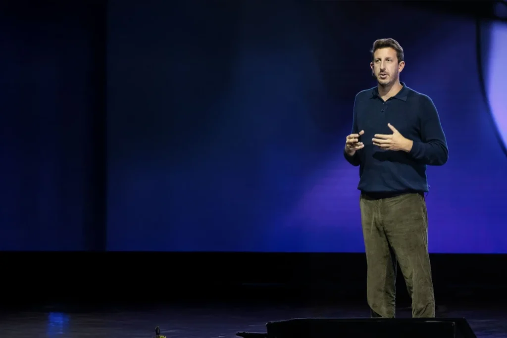 Zack Kass speaking about AI strategy and business transformation at a conference