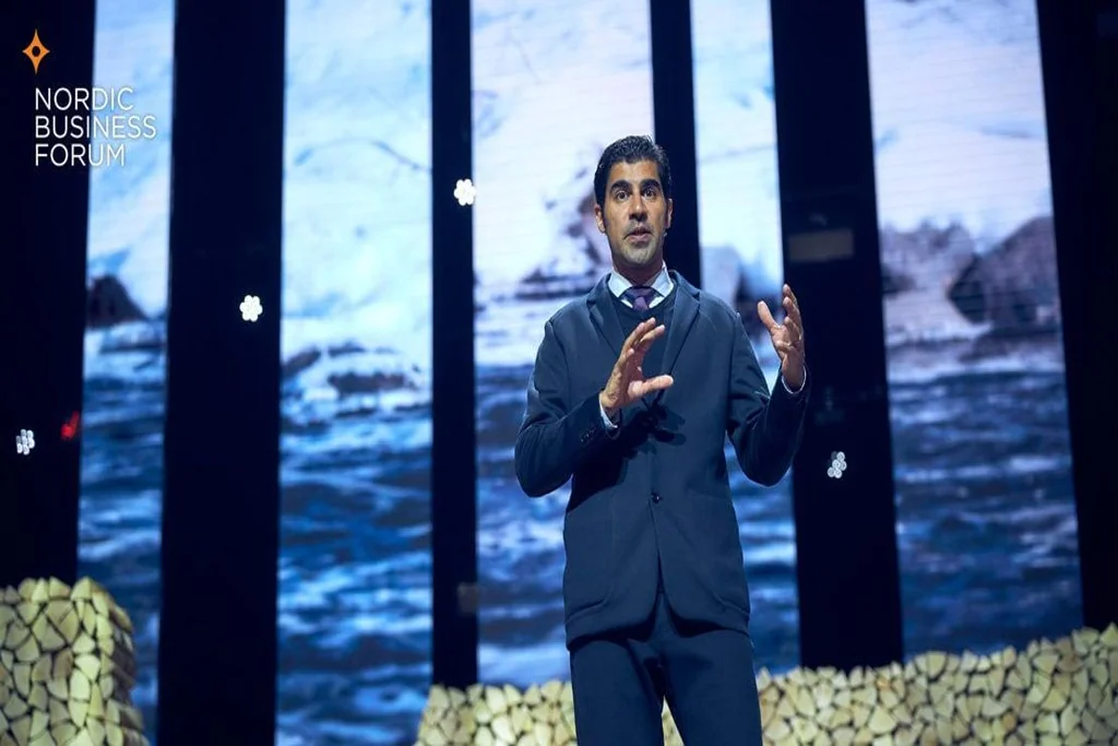 Parag Khanna speaking on stage at Nordic Business Forum with a large visual backdrop
