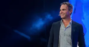 Chris Barton, founder of Shazam, speaking on stage during a keynote presentation.
