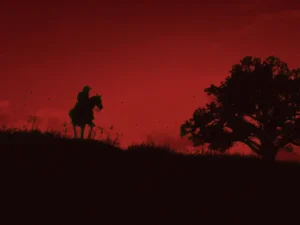 A lone rider on horseback against a red sky beside a lone tree, evoking an open-world game landscape - Christian Cantamessa world-building | Aurum Speakers Bureau