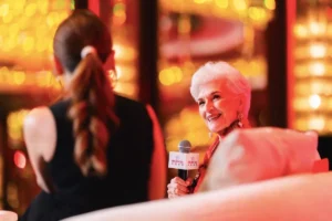 Maye Musk speaking and smiling on the main stage at the Prudential event in Hong Kong - maye musk ageless success | Aurum Speakers Bureau